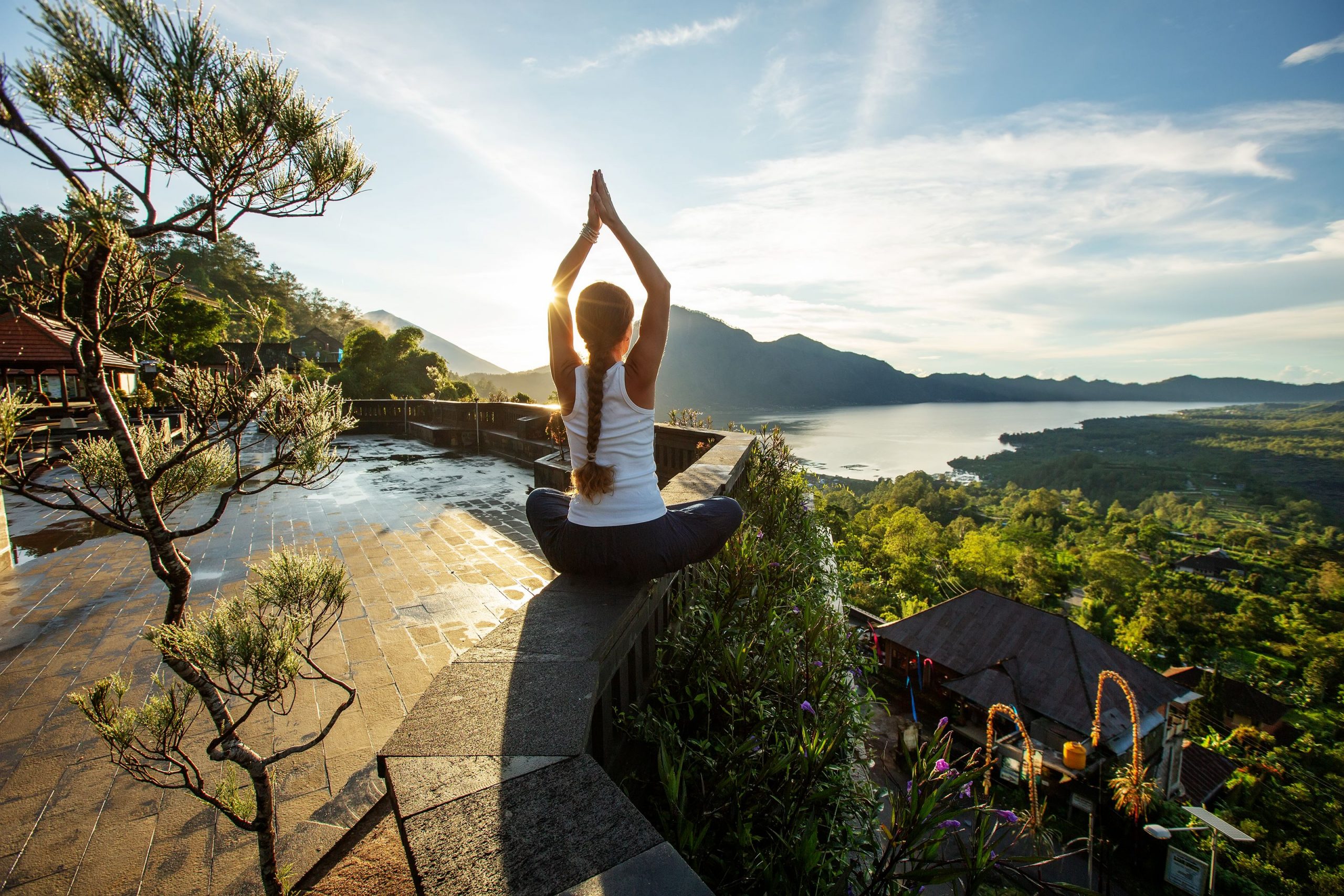 Woman doing yoga at dawn near a volcano on the island of Bali